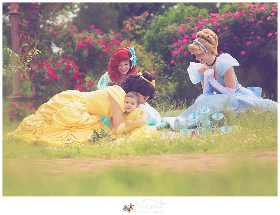 a photography portrait of a little girl battling cancer being surprised with real princesses and a tea party in the roger williams park rose garden with rhode island photographers of massart photography RI, CT, MA