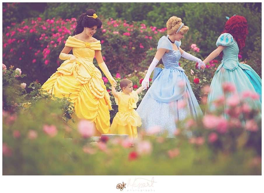 a photography portrait of a little girl battling cancer being surprised with real princesses and a tea party in the roger williams park rose garden with rhode island photographers of massart photography RI, CT, MA