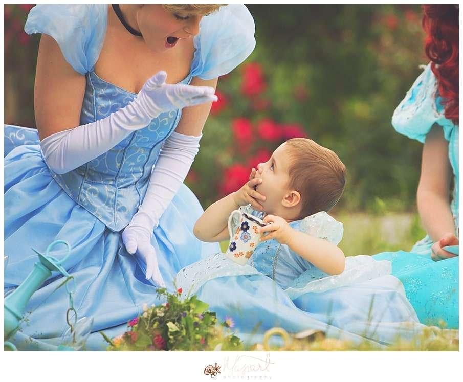 a photography portrait of a little girl battling cancer being surprised with real princesses and a tea party in the roger williams park rose garden with rhode island photographers of massart photography RI, CT, MA