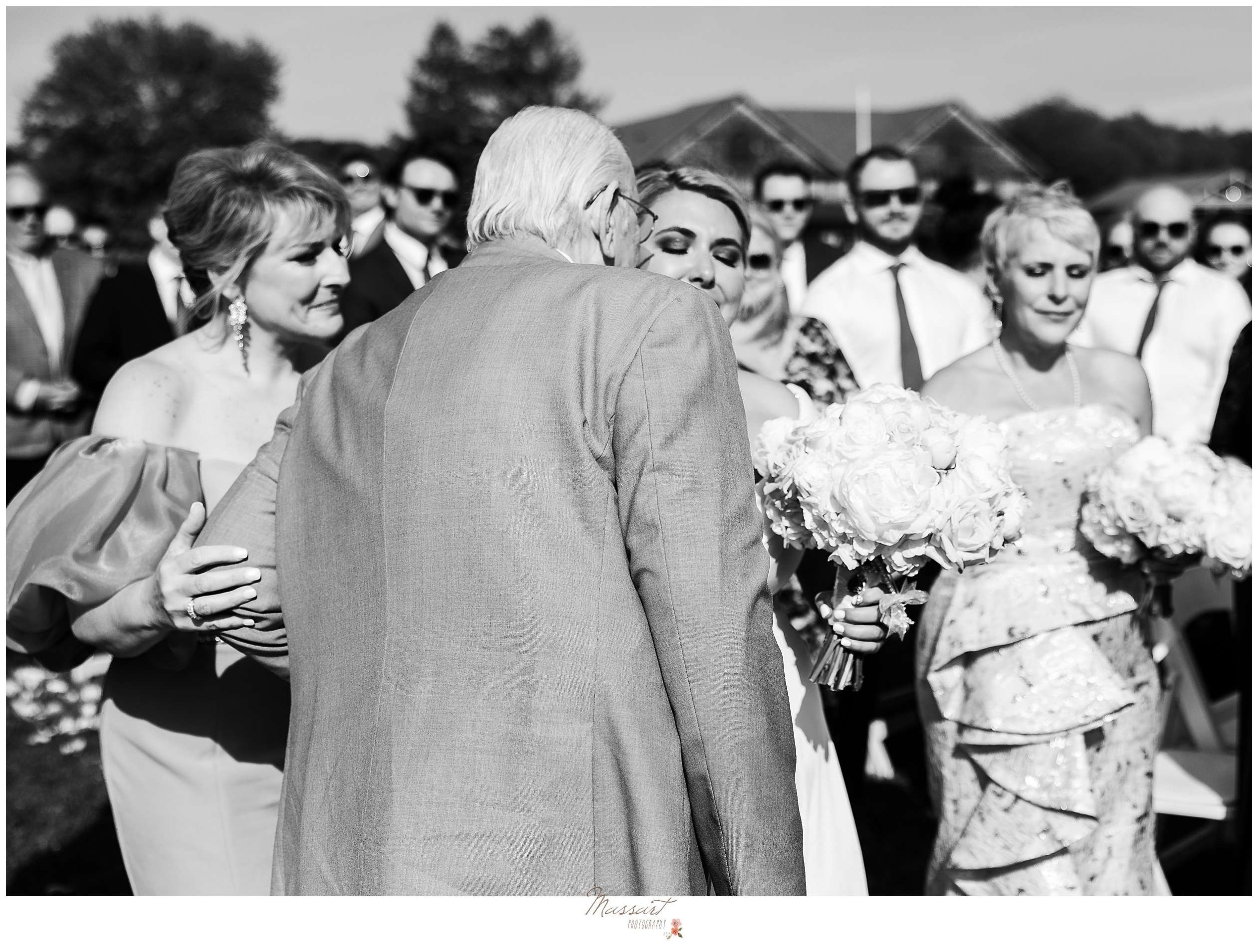 older man kisses bride's cheek during wedding ceremony at Rhode Island