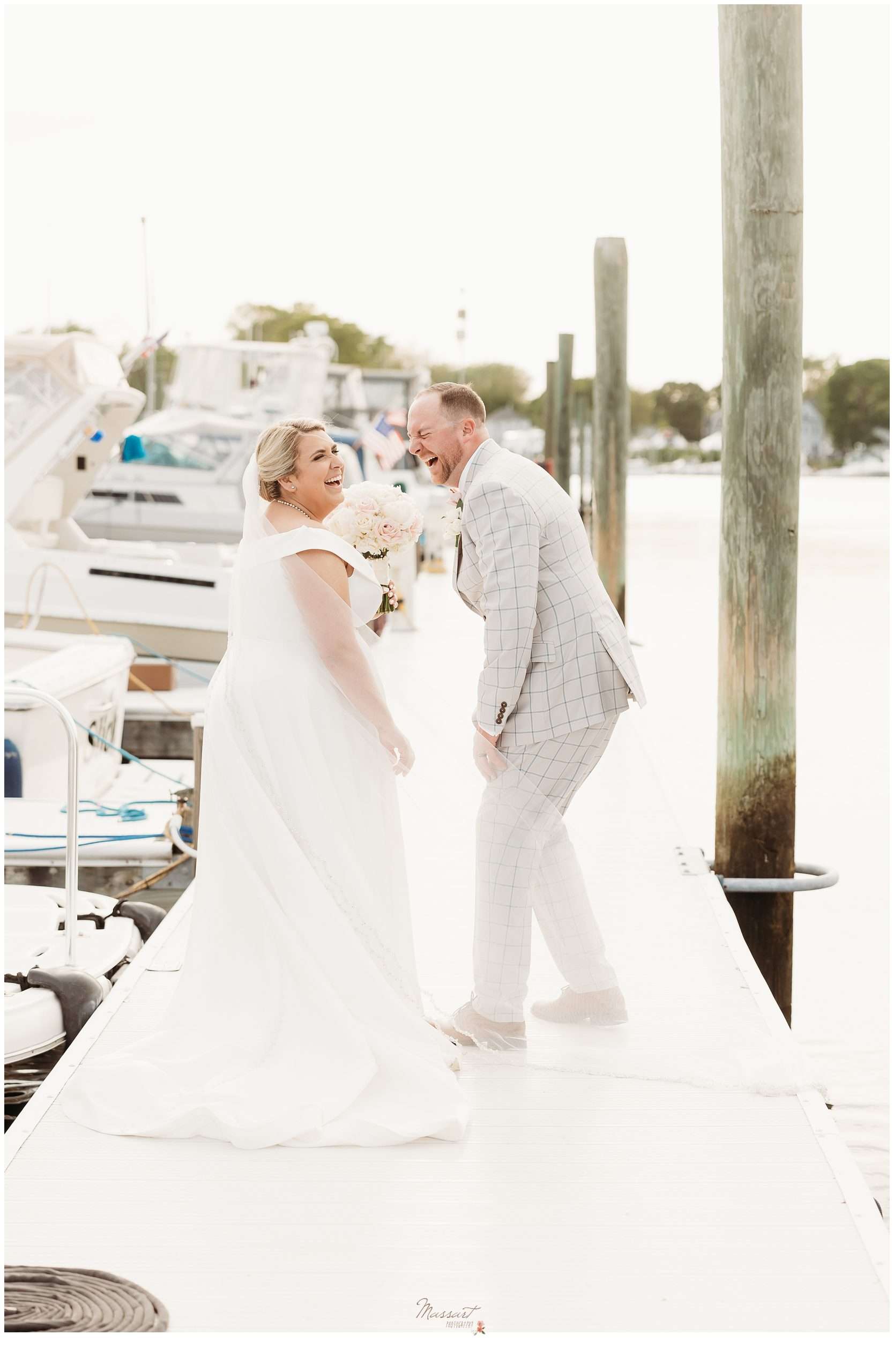 bride and groom laugh on Maria during Harbor Lights wedding day